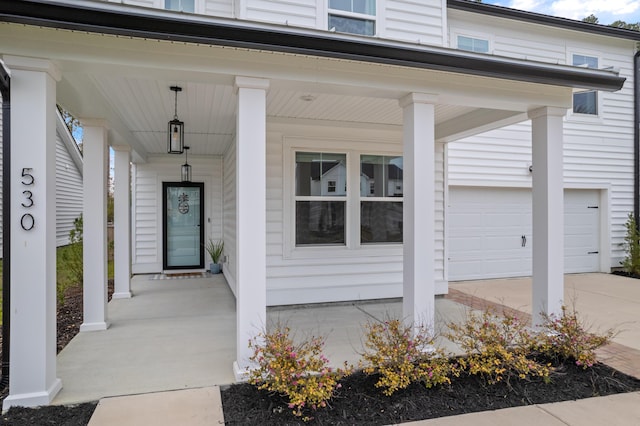 doorway to property featuring a garage and covered porch