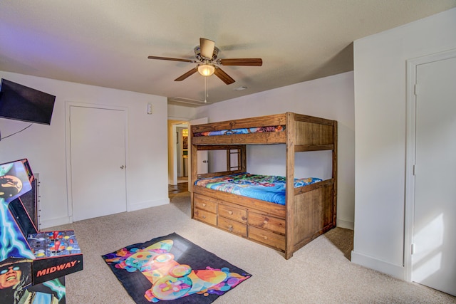 bedroom featuring baseboards, carpet flooring, and a ceiling fan