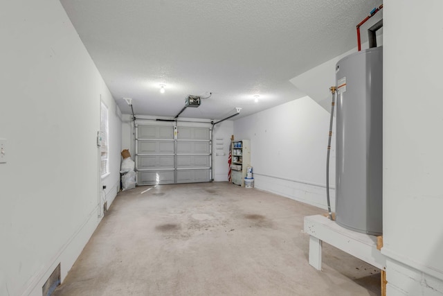 garage featuring water heater, visible vents, and a garage door opener