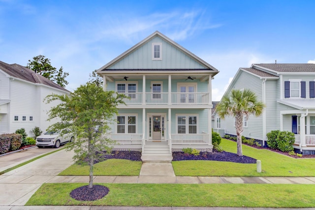 1485 Bourne Xing, Mount Pleasant, SC 29466 - view of front of home featuring a ceiling fan, covered porch, board and batten siding, a balcony, and driveway