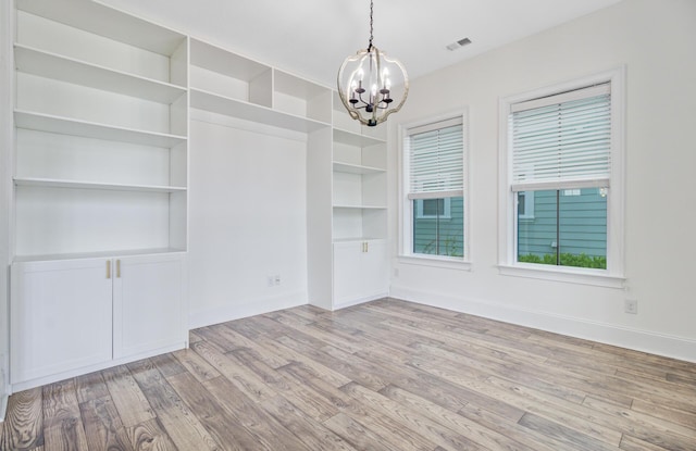 1485 Bourne Xing, Mount Pleasant, SC 29466 - unfurnished dining area featuring a chandelier, wood finished floors, and built in shelves