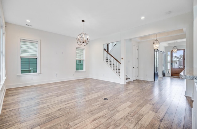 1485 Bourne Xing, Mount Pleasant, SC 29466 - unfurnished living room featuring a chandelier, stairway, healthy amount of natural light, light wood-style floors, and recessed lighting