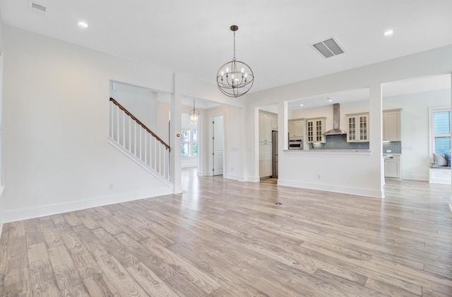1485 Bourne Xing, Mount Pleasant, SC 29466 - unfurnished living room featuring stairway, a chandelier, light wood-type flooring, and recessed lighting