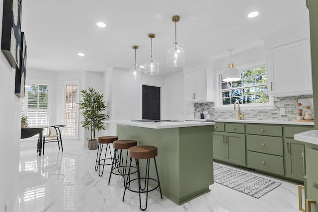 3385 Wayland Dr, Ladson, SC 29456 - kitchen featuring green cabinets, tasteful backsplash, healthy amount of natural light, light marble finish floors, and recessed lighting