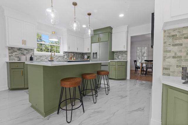3385 Wayland Dr, Ladson, SC 29456 - kitchen featuring light marble finish floors, green cabinetry, backsplash, white cabinetry, and recessed lighting
