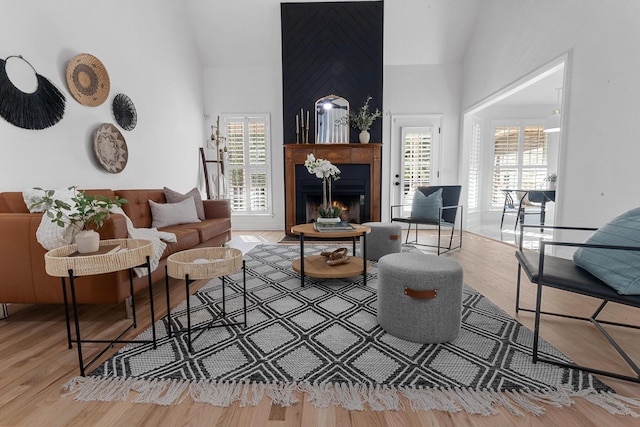 3385 Wayland Dr, Ladson, SC 29456 - living room featuring high vaulted ceiling, plenty of natural light, a lit fireplace, and wood finished floors