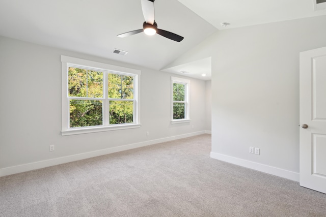 carpeted spare room with ceiling fan and vaulted ceiling