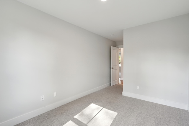 empty room featuring light carpet