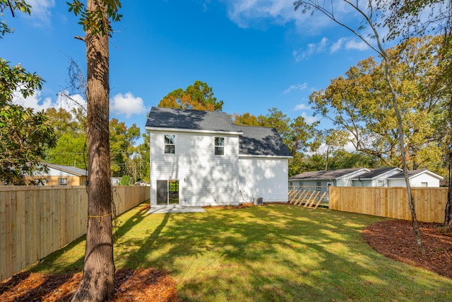 back of property featuring a lawn