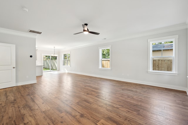 empty room with ceiling fan with notable chandelier, dark hardwood / wood-style floors, and ornamental molding