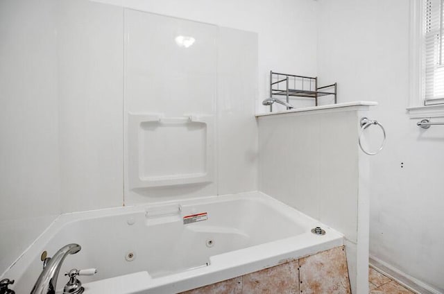 bathroom with a relaxing tiled tub