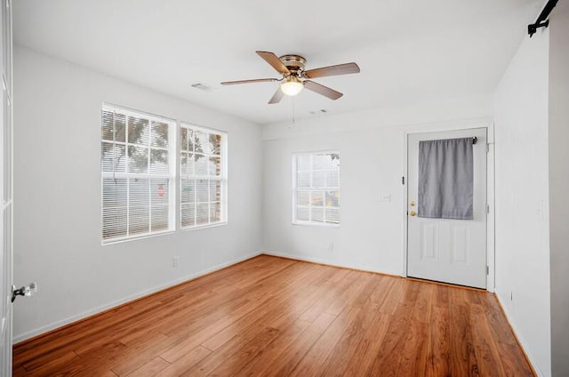 empty room featuring wood-type flooring and ceiling fan