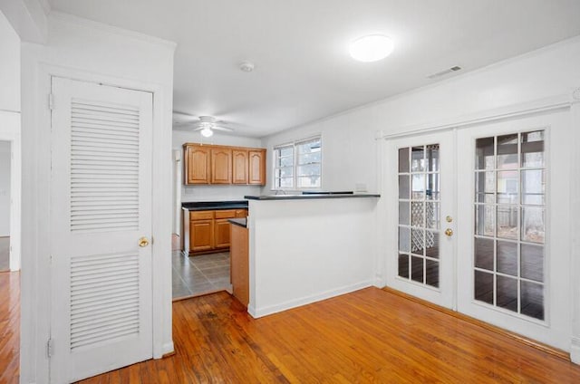 kitchen with dark wood-type flooring, ceiling fan, and french doors