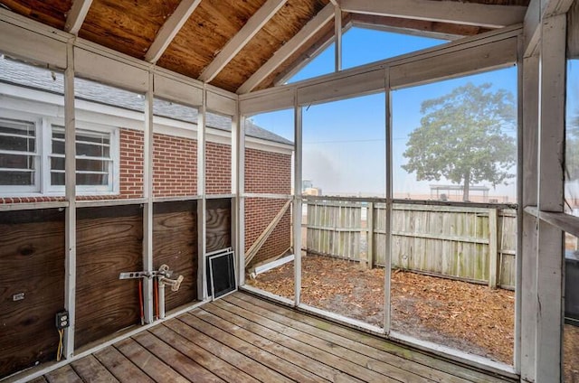 unfurnished sunroom featuring lofted ceiling