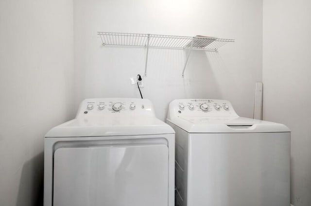 clothes washing area featuring separate washer and dryer