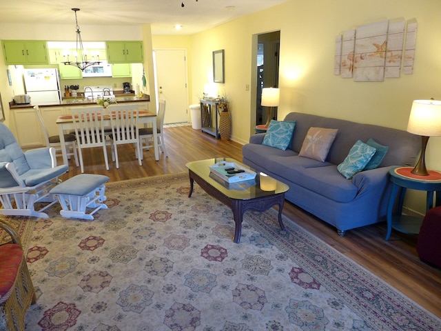 living room with a chandelier and wood-type flooring