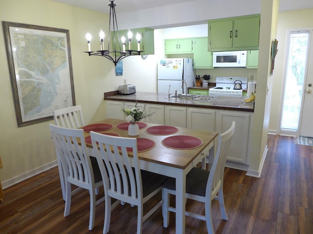 dining area featuring an inviting chandelier, dark wood-type flooring, and sink