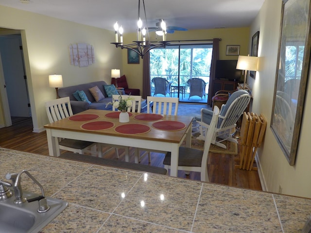 dining room with a chandelier, hardwood / wood-style flooring, and sink