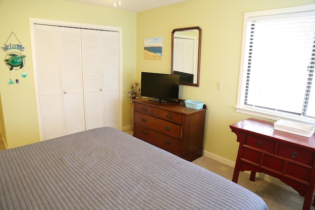 carpeted bedroom featuring a closet