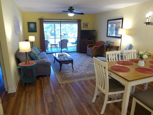 living room featuring ceiling fan and dark hardwood / wood-style floors