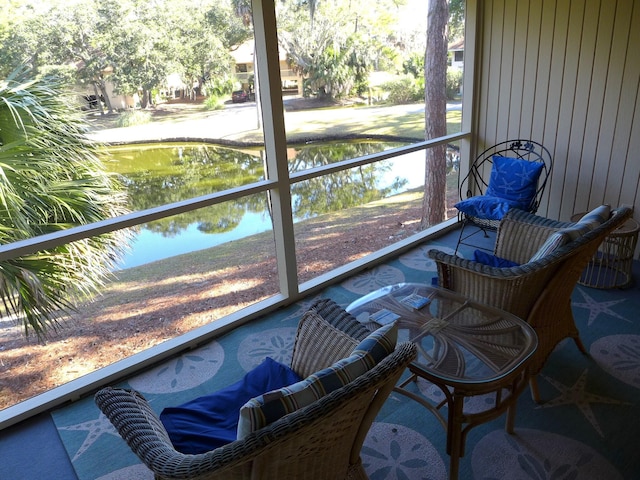 sunroom / solarium featuring a water view