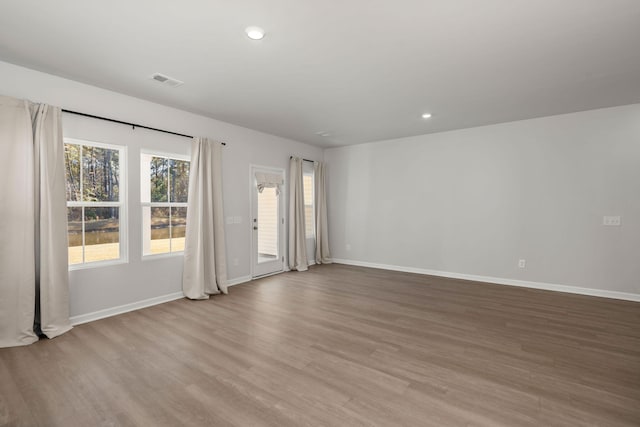 empty room with light hardwood / wood-style flooring