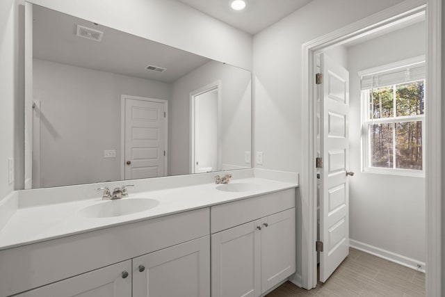 bathroom with tile patterned flooring and vanity