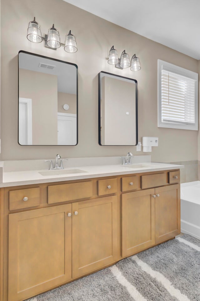 bathroom with vanity and a washtub