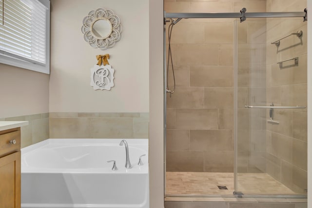 bathroom featuring vanity and separate shower and tub