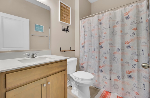 bathroom featuring tile patterned flooring, vanity, and toilet