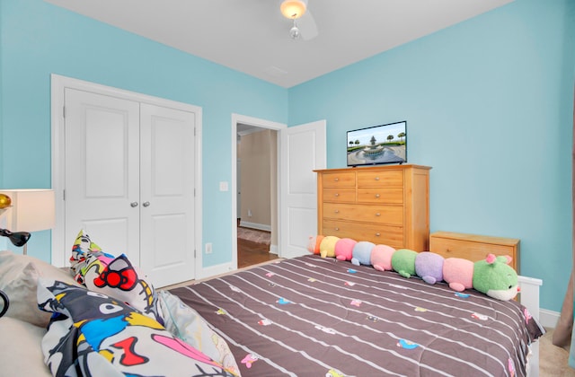 carpeted bedroom with a closet and ceiling fan