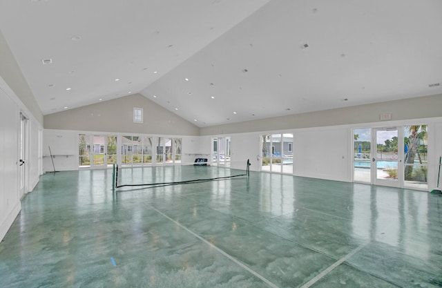 interior space featuring high vaulted ceiling, concrete flooring, and a healthy amount of sunlight