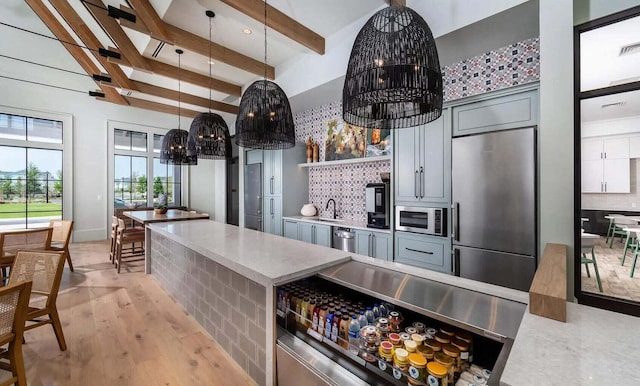 305 Archar St, Summerville, SC 29486 - kitchen with built in refrigerator, stainless steel microwave, beam ceiling, a chandelier, and backsplash
