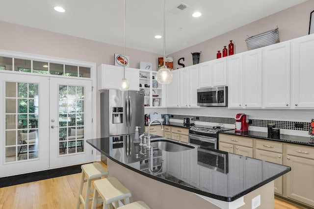 656 Coleman Blvd Unit 703, Mount Pleasant, SC 29464 - kitchen featuring stainless steel appliances, a sink, french doors, open shelves, and a breakfast bar