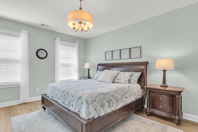 656 Coleman Blvd Unit 703, Mount Pleasant, SC 29464 - bedroom featuring wood finished floors, a chandelier, and baseboards