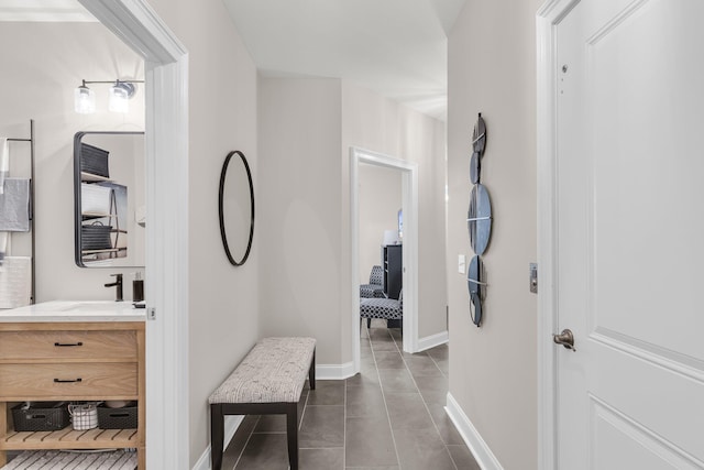 656 Coleman Blvd Unit 703, Mount Pleasant, SC 29464 - hallway with dark tile patterned floors, a sink, and baseboards