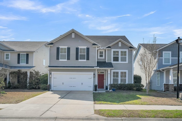 traditional-style house with a garage, driveway, and a front lawn