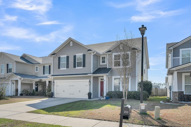 view of front facade with a garage, driveway, and a front lawn