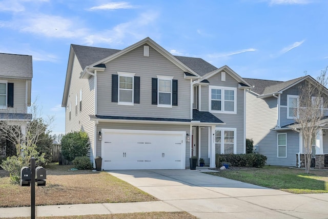 traditional-style home with an attached garage and concrete driveway