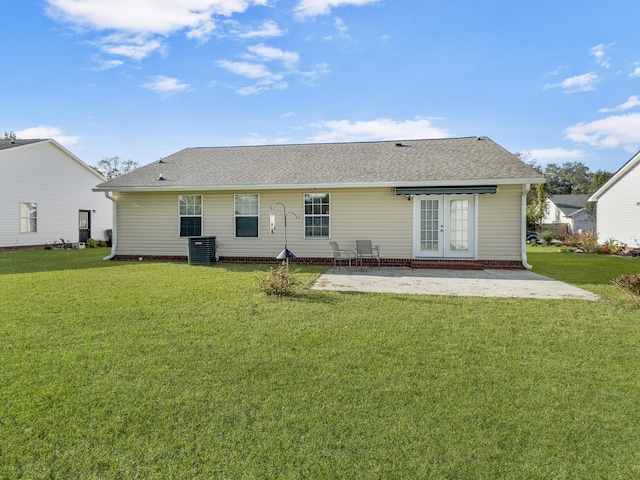 rear view of house with central AC, a yard, and a patio area