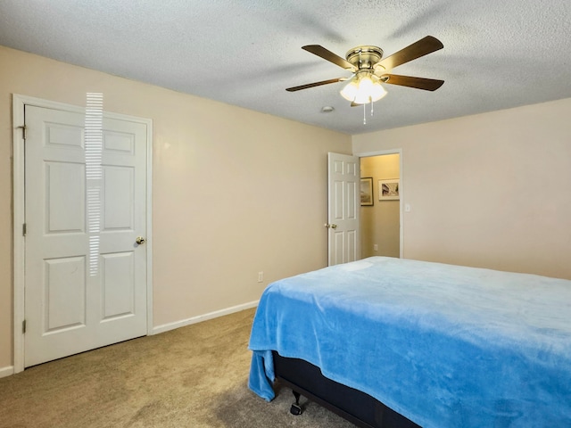 carpeted bedroom with a textured ceiling and ceiling fan