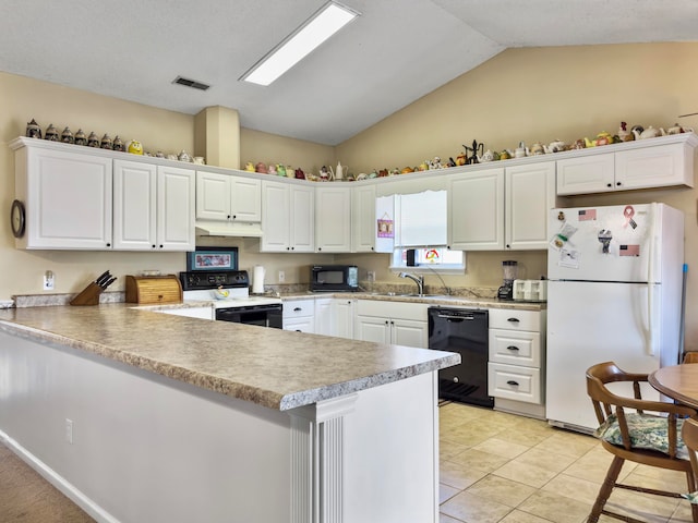 kitchen with black appliances, kitchen peninsula, and white cabinets