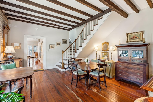 dining space with hardwood / wood-style floors, stairway, beam ceiling, and baseboards