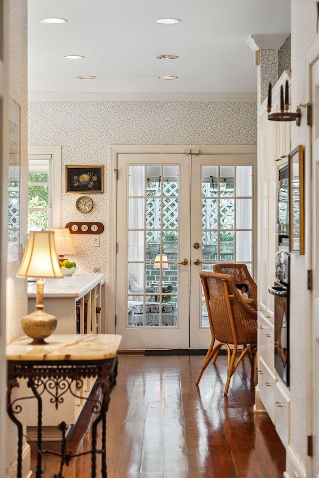 entryway with crown molding, french doors, hardwood / wood-style flooring, and wallpapered walls