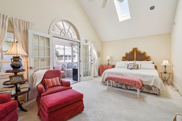 carpeted bedroom featuring a skylight, french doors, a ceiling fan, high vaulted ceiling, and access to outside