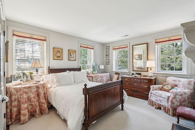 bedroom featuring light carpet and visible vents