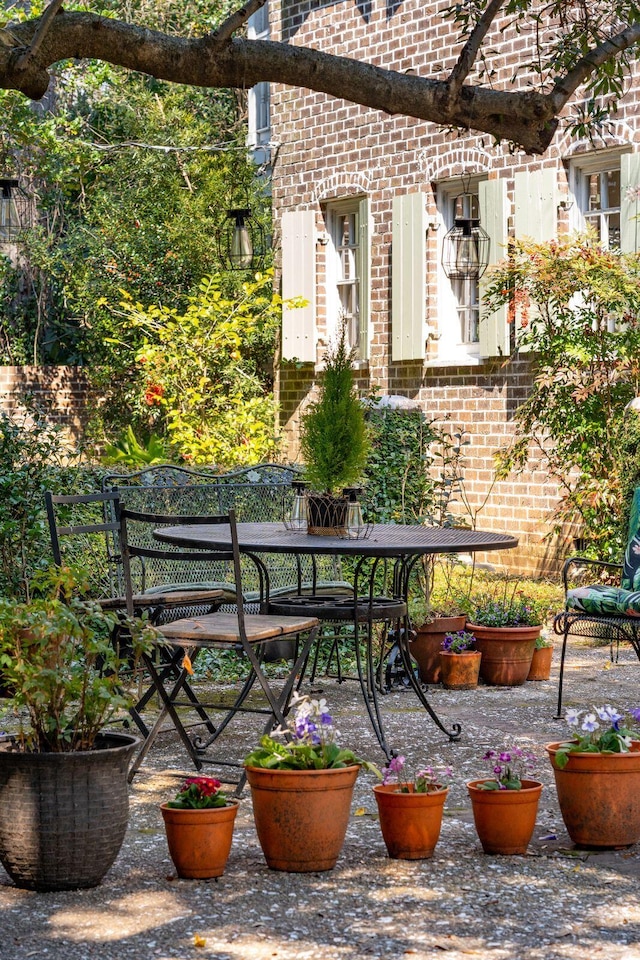 balcony with outdoor dining space and a patio