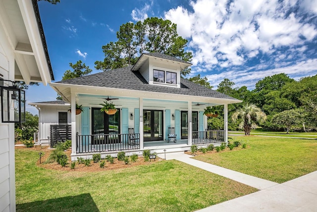 view of front of home featuring a porch, a front lawn, and french doors