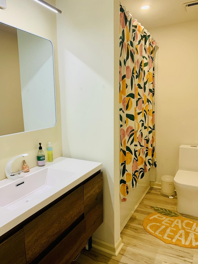 1202 Ventura Pl, Mount Pleasant, SC 29464 - bathroom featuring toilet, wood finished floors, vanity, visible vents, and baseboards