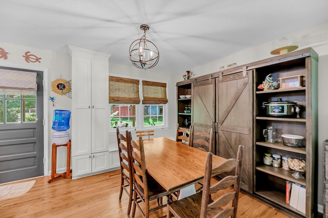 7274 Commodore Rd, Hollywood, SC 29449 - dining area with a barn door, light wood-type flooring, plenty of natural light, and a chandelier